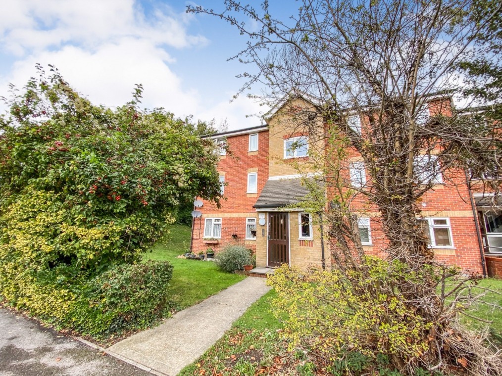 Two-bedroom upper floor flat at Rookley Court, surrounded by greenery, featuring a modern entrance and residential setting in Purfleet-On-Thames, Essex.